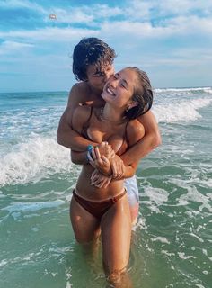 two women in the ocean hugging each other