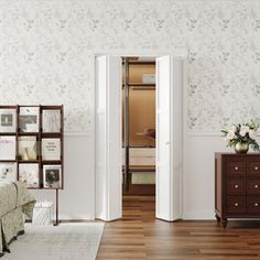 a bedroom with white walls and wooden floors