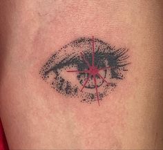 a close up of a person's leg with an eye tattoo