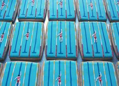 decorated cookies with blue frosting depicting athletes