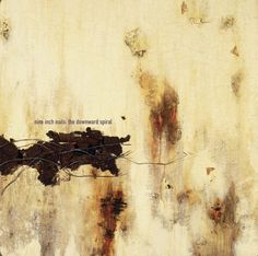 an old rusted wall with the words nine inch nails, the downward spiral written on it