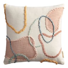 a decorative pillow with various colored beads on the front and back of it, along with a white background