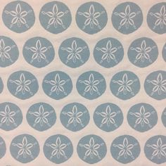 a blue and white fabric with small circles in the shape of starfishs on it