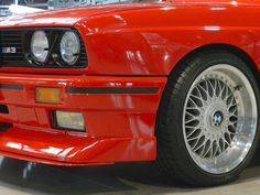 the front end of an orange bmw sports car