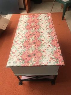 an old dresser is covered with floral fabric