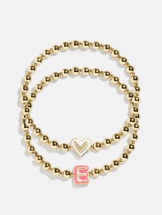 Give your mini the best of both worlds when you scoop up this two-in-one, super stackable bracelet set. The Initial & Heart Kids' Pisa Bracelet Set will feature the initial of your choosing crafted in vibrant enamel and flanked by gold ball beads. We paired each initial with a white enamel heart bracelet, ensuring your little's bracelet stack will be extra meaningful. READY TO GIFT: This item comes pre-packaged in a beautiful box. Please note: intended for children 3+ Kids Gold Jewelry, Heart Kids, Preppy Jewelry, Birthday Gifts For Teens, Kids Bracelets, Beads Bracelet Design, Jewelry Accessories Ideas, Gold Bead Bracelets, Initial Jewelry