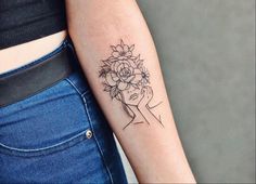 a woman with a flower tattoo on her arm