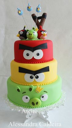 a three tiered cake decorated with angry birds and other characters on it's sides