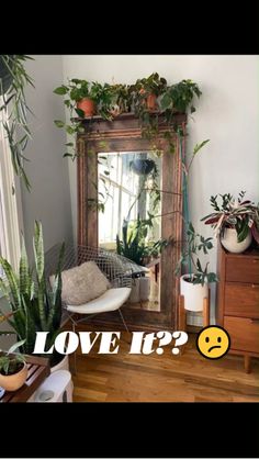 a room with plants and a mirror that says love if?