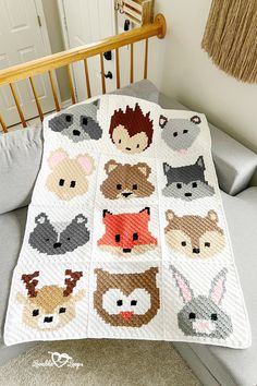 a crocheted baby blanket with animals on it