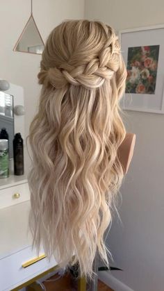 the back of a woman's head with long blonde hair and braid in it