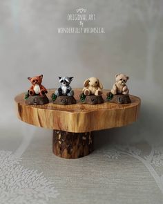 small figurines of animals sitting on top of a wooden stand with the word wonderful whimsical written below them