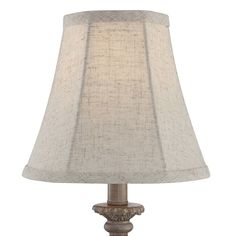 a table lamp with a beige shade on it's base and a white linen lampshade