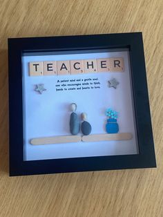 a shadow box frame with scrabbles and magnets in it that says teacher