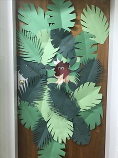a door decorated with paper leaves and an animal
