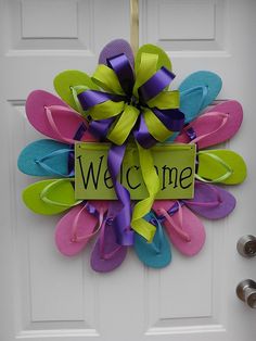 a welcome door hanger with flip flops on it