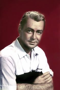 a man wearing a white shirt and black tie posing for a photo in front of a red background