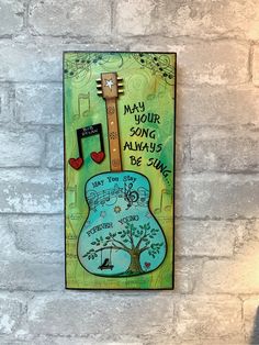 a painting on a brick wall that says may your song always be sungg