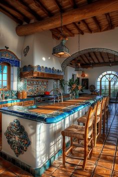 a large kitchen with an island counter and wooden chairs