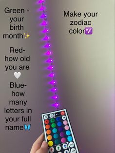 a hand holding a remote control in front of a wall with the words make your birth month