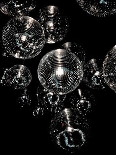 an array of shiny disco balls on a black background