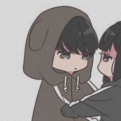 two people in hoodies hugging each other