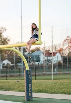 Cheerleader football senior photos at sunset Cheer Pictures On Bleachers, Senior Picture Cheer Ideas, Cheerleading Senior Banner Poses, Senior Sibling Picture Ideas, Athletic Trainer Photoshoot, High School Cheer Picture Poses, Cheer Pic Poses Individual, Senior Photos Football Field, High School Dance Team Photos