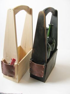 a wooden holder with bottles in it on a white table next to a pair of scissors