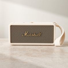 a white and black speaker sitting on top of a table