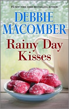 the cover of rainy day kisses by debie macomber is shown on a table next to a cup and saucer