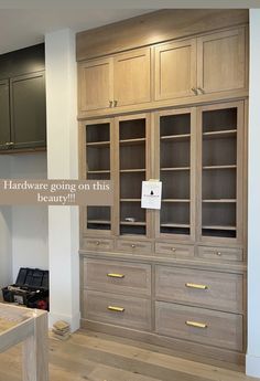 an empty room with wooden cabinets and drawers