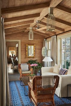 a living room filled with furniture and windows