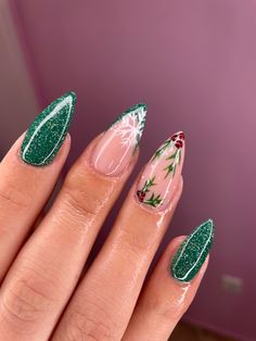 Woman nails with Christmas design in green colour Acrylic Nails Christmas Design, Nails Xmas Design, Christmas Almond Acrylic Nails, December Nail Ideas Gel, Nails Holiday Christmas, Green Glitter Nails Christmas, Nails 2023 Christmas, Nails December 2023, Green Nails With Snowflake