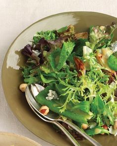 a salad with lettuce and nuts in a bowl