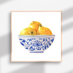 a painting of two lemons in a blue and white bowl with floral designs on it