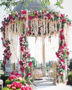 an outdoor ceremony with flowers and greenery