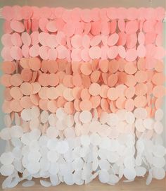 an art work made out of paper circles and pink, white, and orange colors