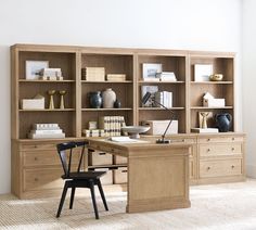 a desk and chair in front of an open bookcase