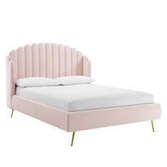 a pink bed with gold legs and headboard