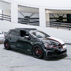 a black and white car parked in front of a building