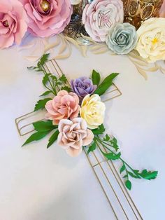 paper flowers are arranged on a gold wire frame and placed in front of a mirror