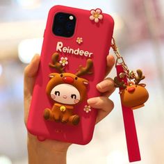 a person holding up a red phone case with a cow on it and a keychain