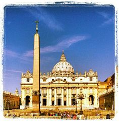 a large building with a tall obelisk in front of it's center