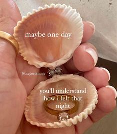 someone is holding two seashells with their wedding rings on them and the words maybe one day you'll understand how i felt that night