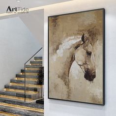 a horse painting hanging on the wall next to some stairs and a staircase case with wooden handrails