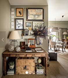 a living room filled with lots of furniture and pictures on the wall above it's coffee table