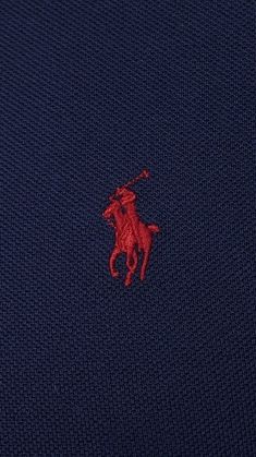 the polo shirt has a red horse on it