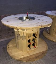 two tables with wine bottles on them sitting next to each other