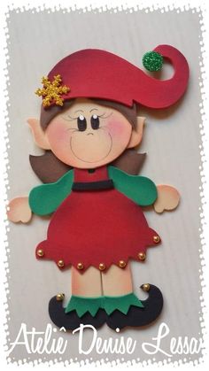 a paper doll with a red hat and green dress