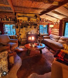 a living room filled with furniture and a fire place in the middle of it's walls